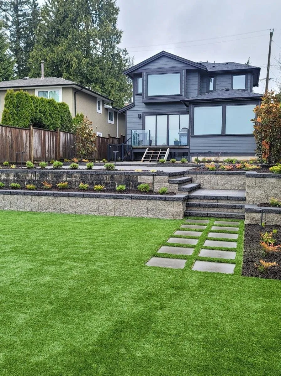 Backyard after: turf, retaining wall, steps and planting