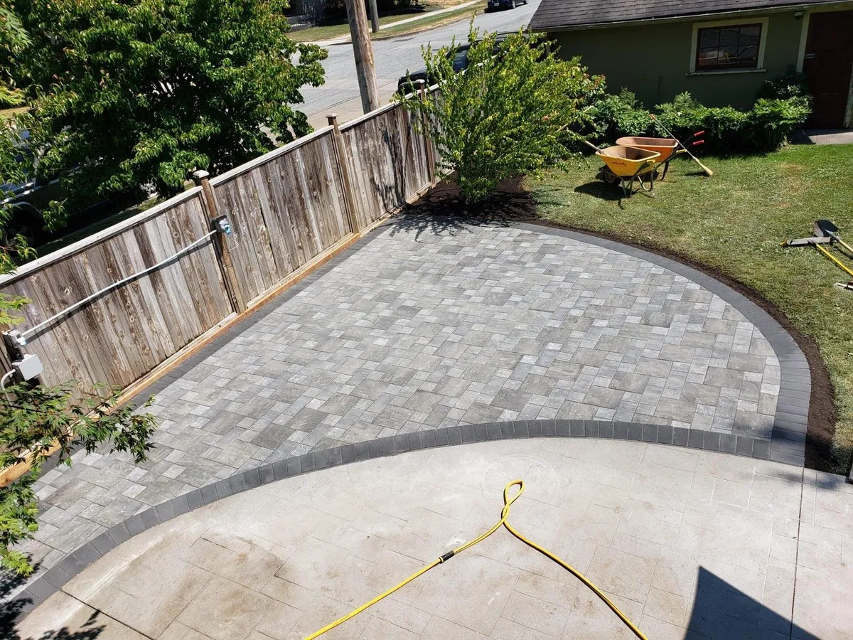Patio after: circular pavers with a dark soldier-course border