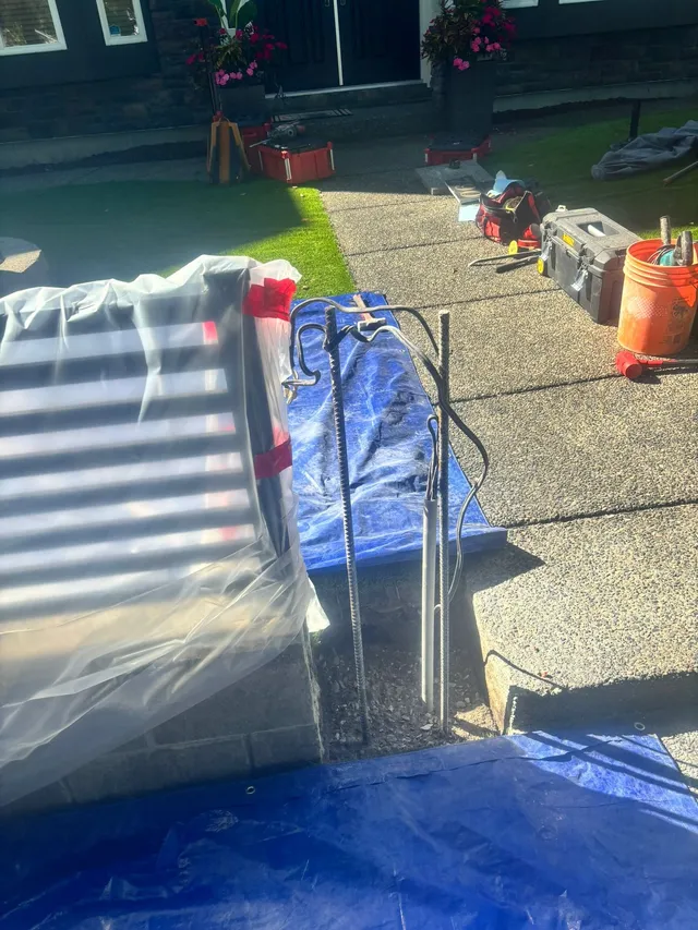 Materials staged on the walkway during the fence installation